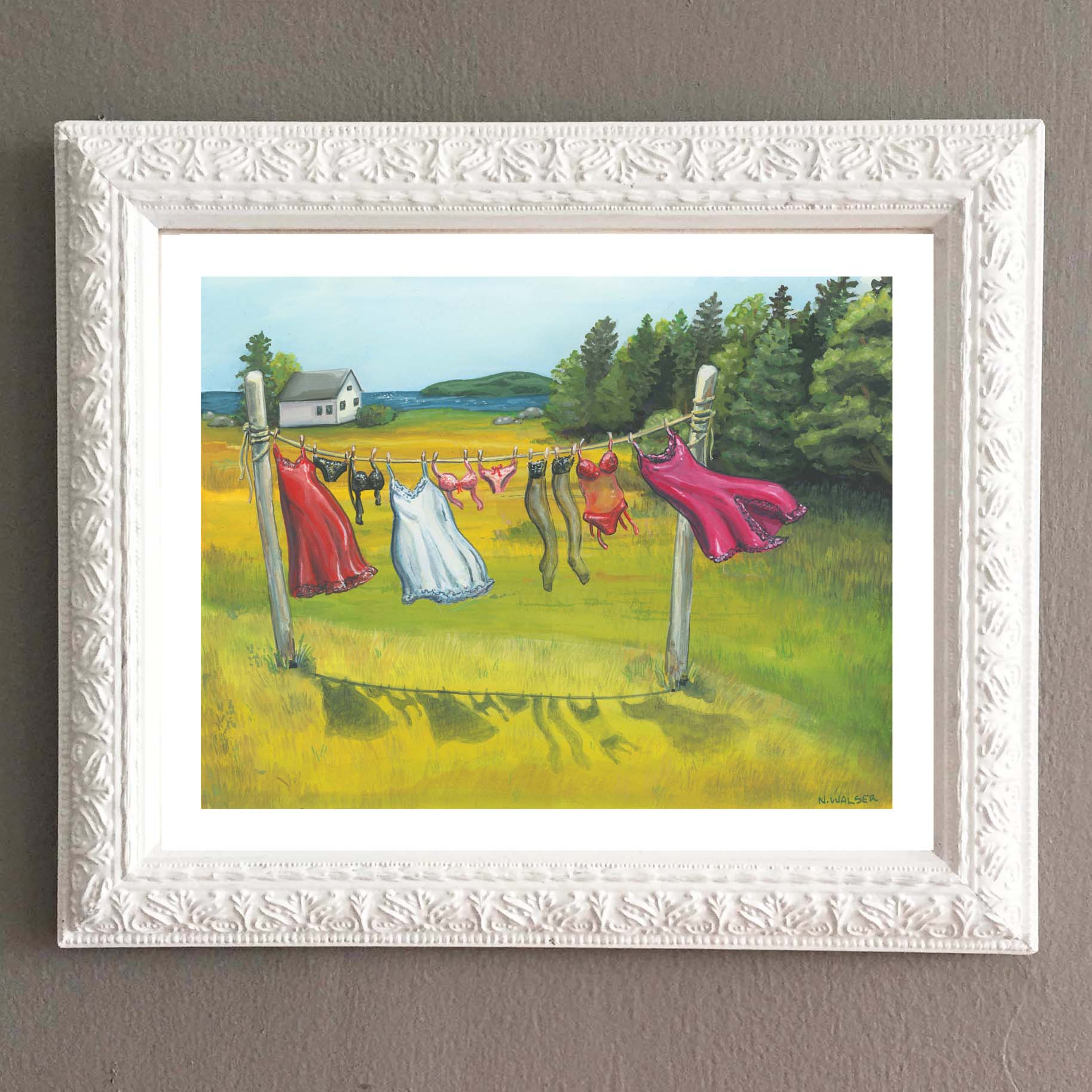 Framed artwork of colorful dresses and lingerie hanging on a clothesline in a field.