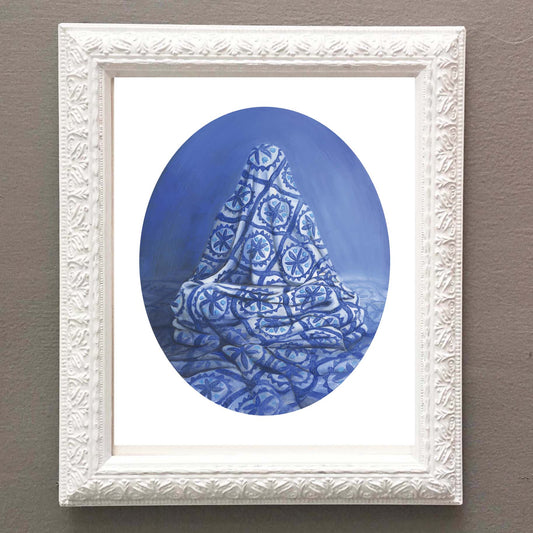 Framed artwork of a blue quilt with figure underneath