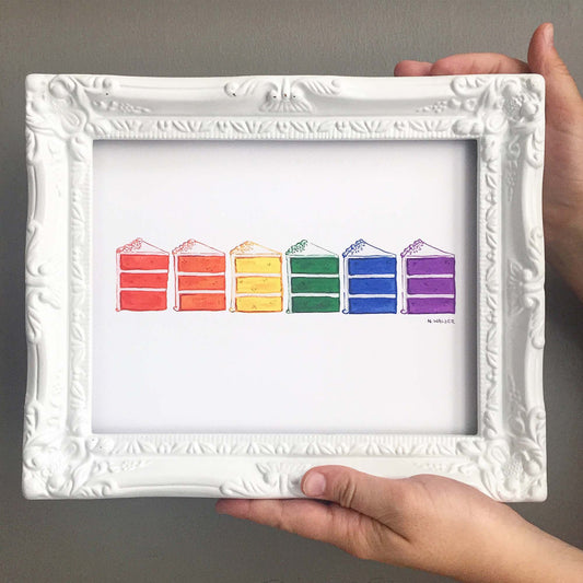 Framed artwork of rainbow-colored cake slices
