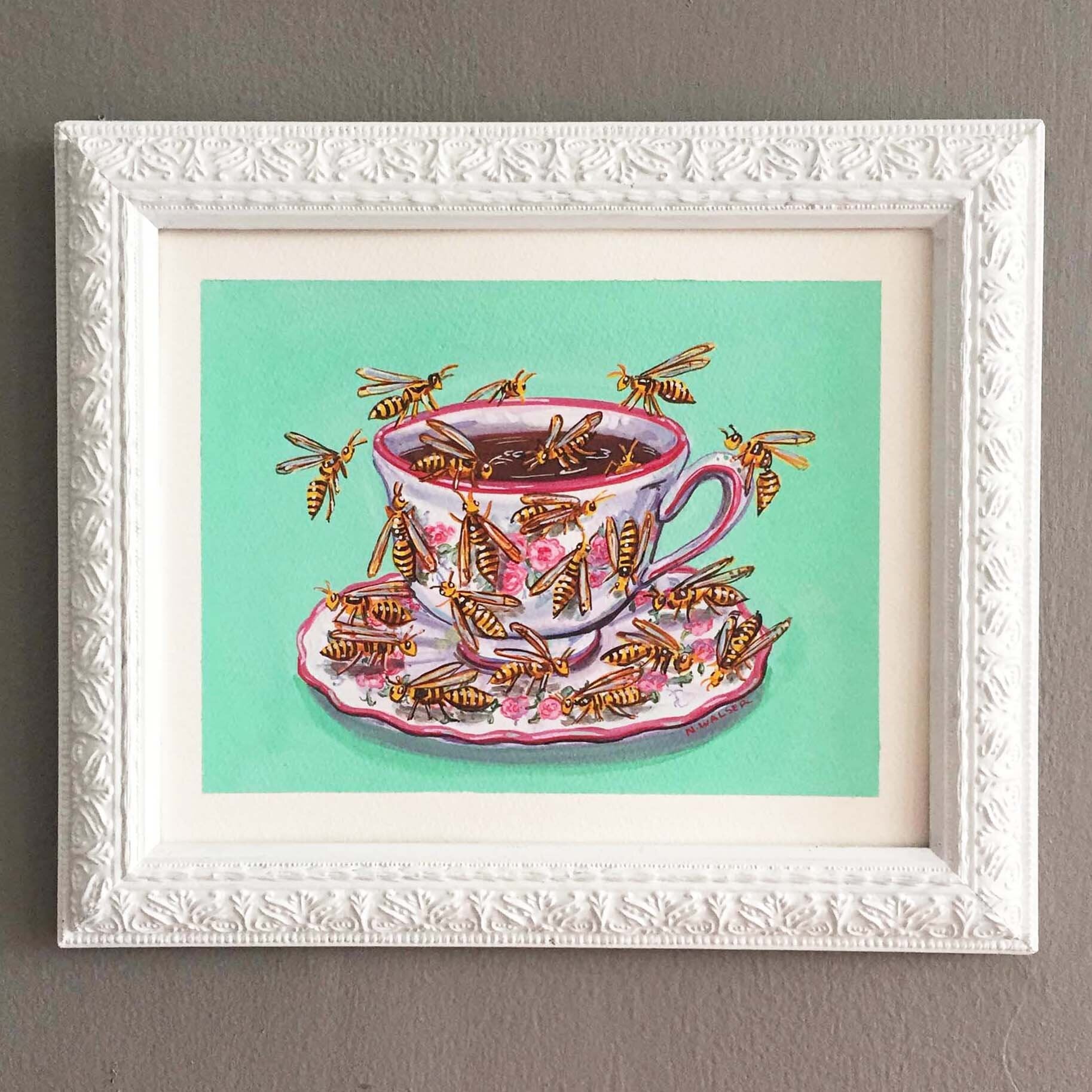 Framed artwork of a teacup with flowers and wasps on a mint green background