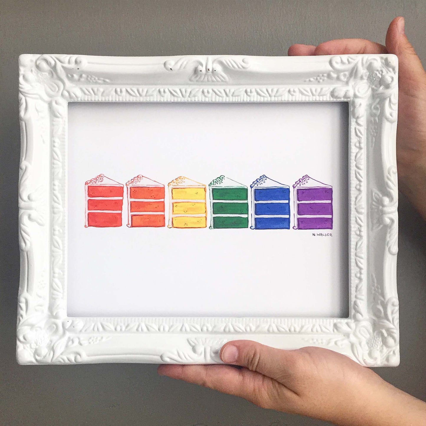 Framed artwork of rainbow-colored cake slices