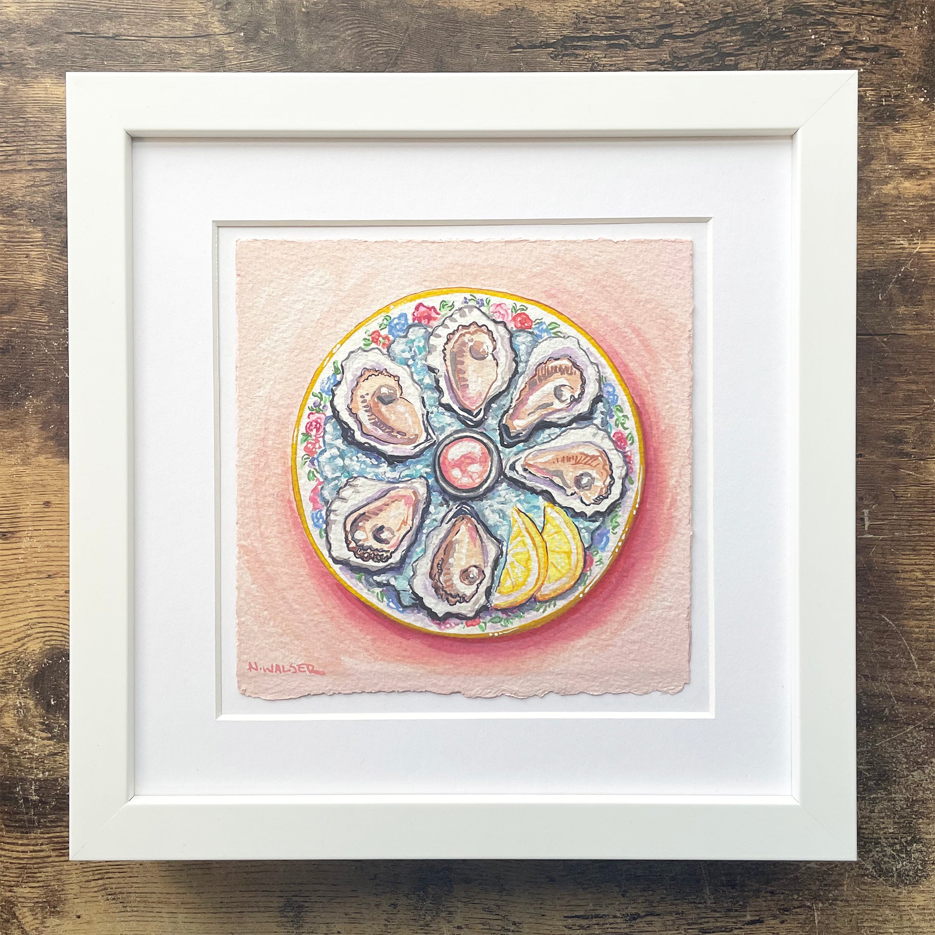Framed artwork of a plate with oysters and flowers on a wooden surface