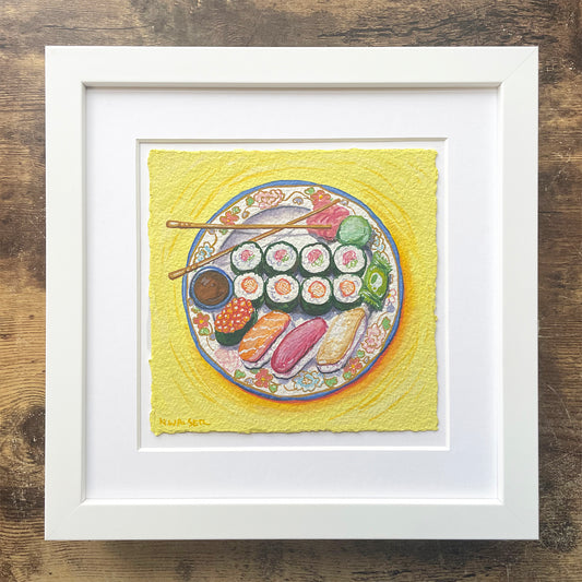 Framed artwork of a plate of sushi on a yellow background